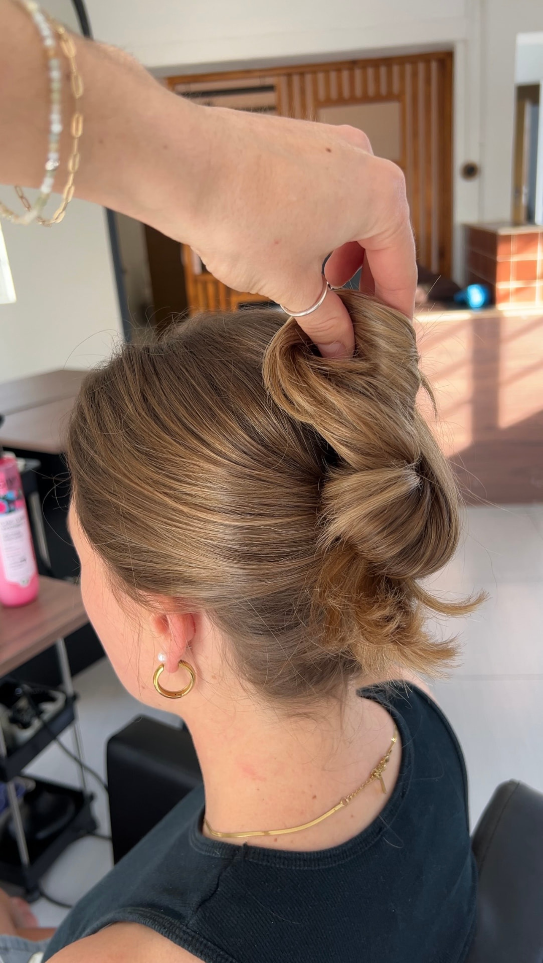 A textured updo in progress, lifted and twisted into place